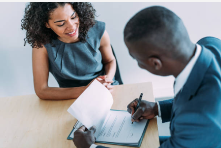 African business professionals reviewing automated workflow